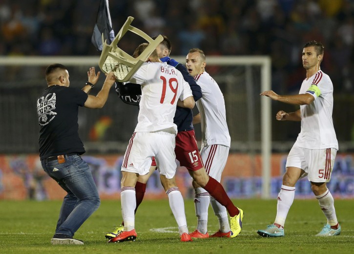 Fans and players of Serbia and Albania clash during their Euro 2016 Group I qualifying soccer match at the FK Partizan stadium in Belgrade October 14, 2014. The Euro 2016 qualifier between Serbia and Albania was halted in the first half on Tuesday following a brawl between players from both sides.          REUTERS/Marko Djurica (SERBIA  - Tags: SPORT SOCCER TPX IMAGES OF THE DAY)