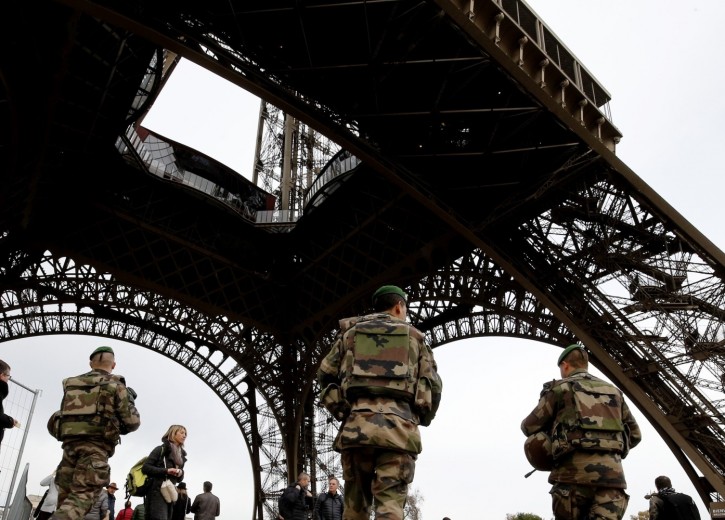 French soldiers patrol the area at the foot of the Eiffel Tower in Paris on November 14, 2015 following a series of coordinated attacks in and around Paris late Friday which left more than 120 people dead. French President Francois Hollande blamed the Islamic State group for the attacks in Paris that left at least 128 dead, calling them an "act of war". The multiple attacks across the city late Friday were "an act of war... committed by a terrorist army, the Islamic State, against France, against... what we are, a free country," Hollande said. AFP PHOTO / FRANCOIS GUILLOT (Photo credit should read FRANCOIS GUILLOT/AFP/Getty Images)