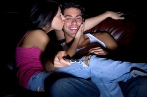 couple watching movie and kissing