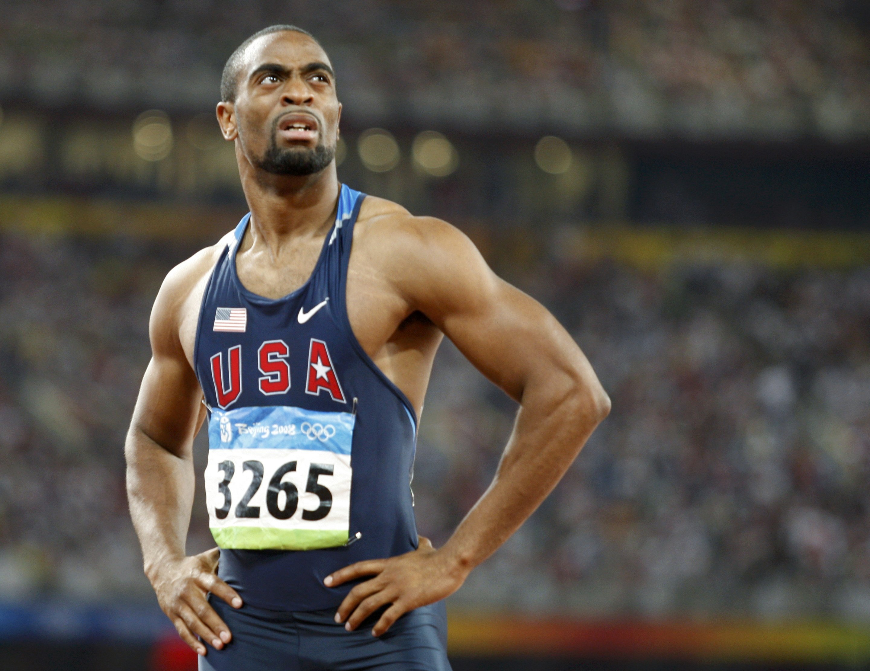 Tyson Gay of the U.S. looks at the scoreboard after his men's 100m semi-final of the athletics competition at the National Stadium during the Beijing 2008 Olympic Games, August 16, 2008.     REUTERS/Gary Hershorn (CHINA)