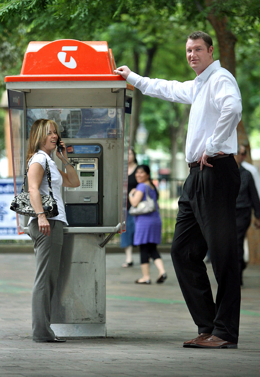 Mandatory Credit: Photo by D Marzolla/Newspix / Rex Features ( 700412c ) Neil Fingleton on the Church Street Mall in Parramatta, while Sonnia Ryan who is on the telephone looks on. He is in Australia to look for his Australian counterpart to put into the Guinness Book of Records Britain's tallest man Neil Fingleton visiting Sydney, Australia - 14 Oct 2007