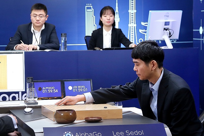 SEOUL, SOUTH KOREA - MARCH 13:  In this handout image provided by Google, South Korean professional Go player Lee Se-Dol (R) puts his first stone against Google's artificial intelligence program, AlphaGo, during the fourth Google DeepMind Challenge Match on March 13, 2016 in Seoul, South Korea. Lee Se-dol played a five-game match against a computer program developed by a Google, AlphaGo.  (Photo by Google via Getty Images)