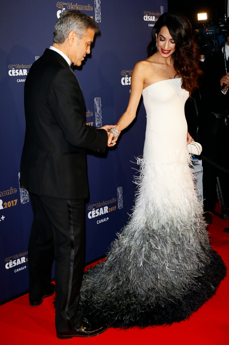 Actor George Clooney and Amal Clooney arrive at the 42nd Cesar Film Awards ceremony at Salle Pleyel in Paris, Friday, Feb. 24, 2017. This annual ceremony is presented by the French Academy of Cinema Arts and Techniques. (AP Photo/Francois Mori)